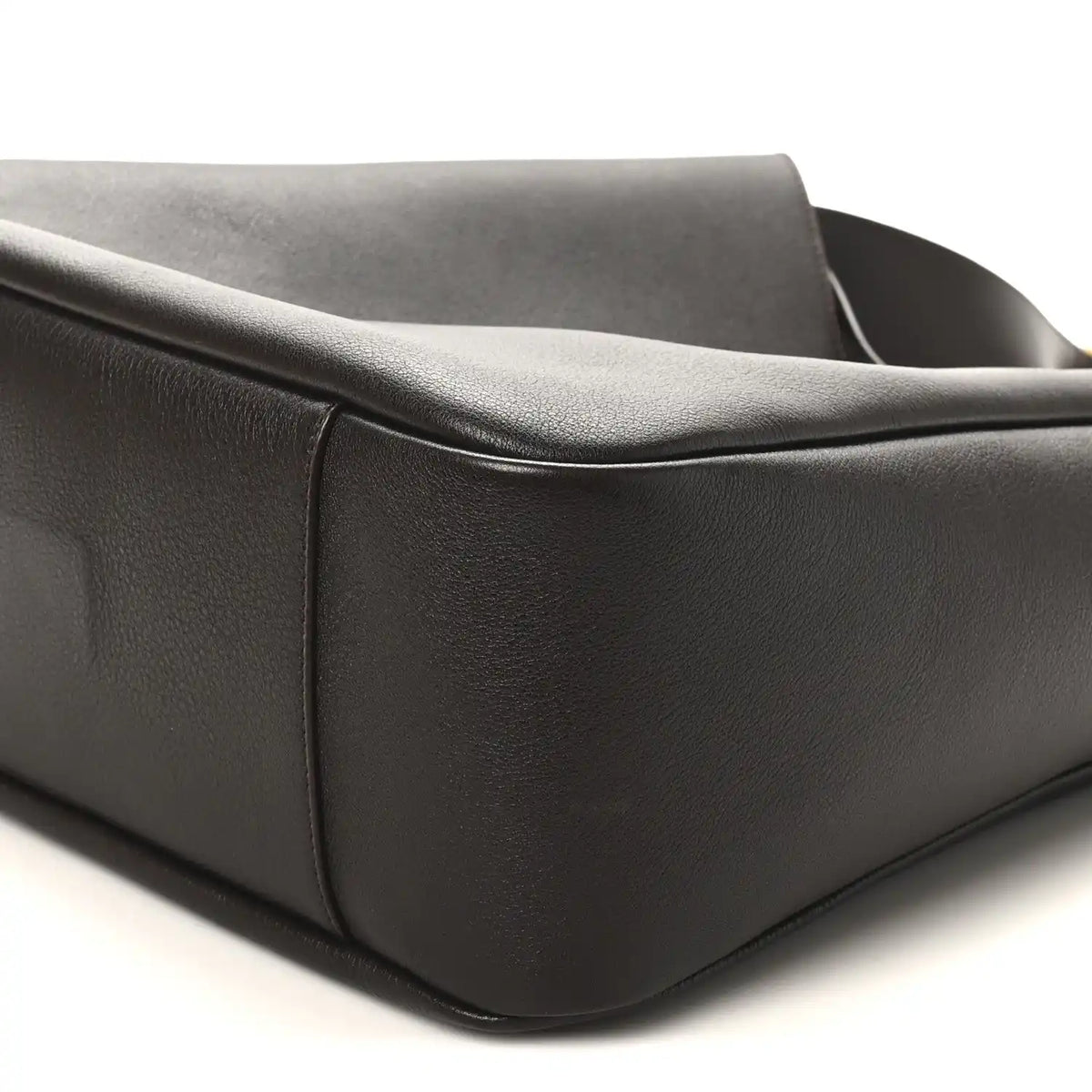 Corner and side seam of dark leather hobo bag with rounded base