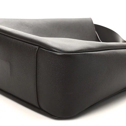 Corner and side seam of dark leather hobo bag with rounded base