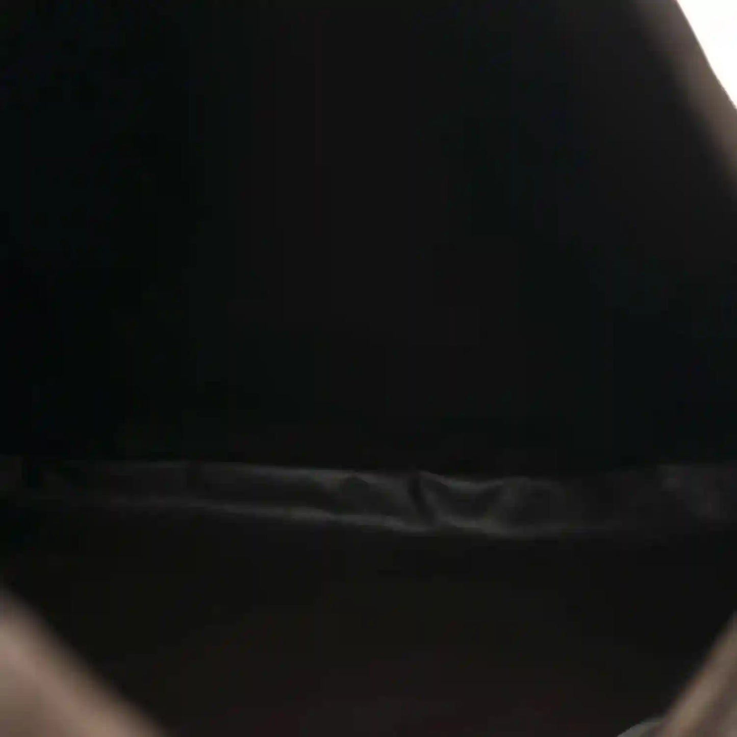 Suede hobo bag interior near zipper opening, dark brown