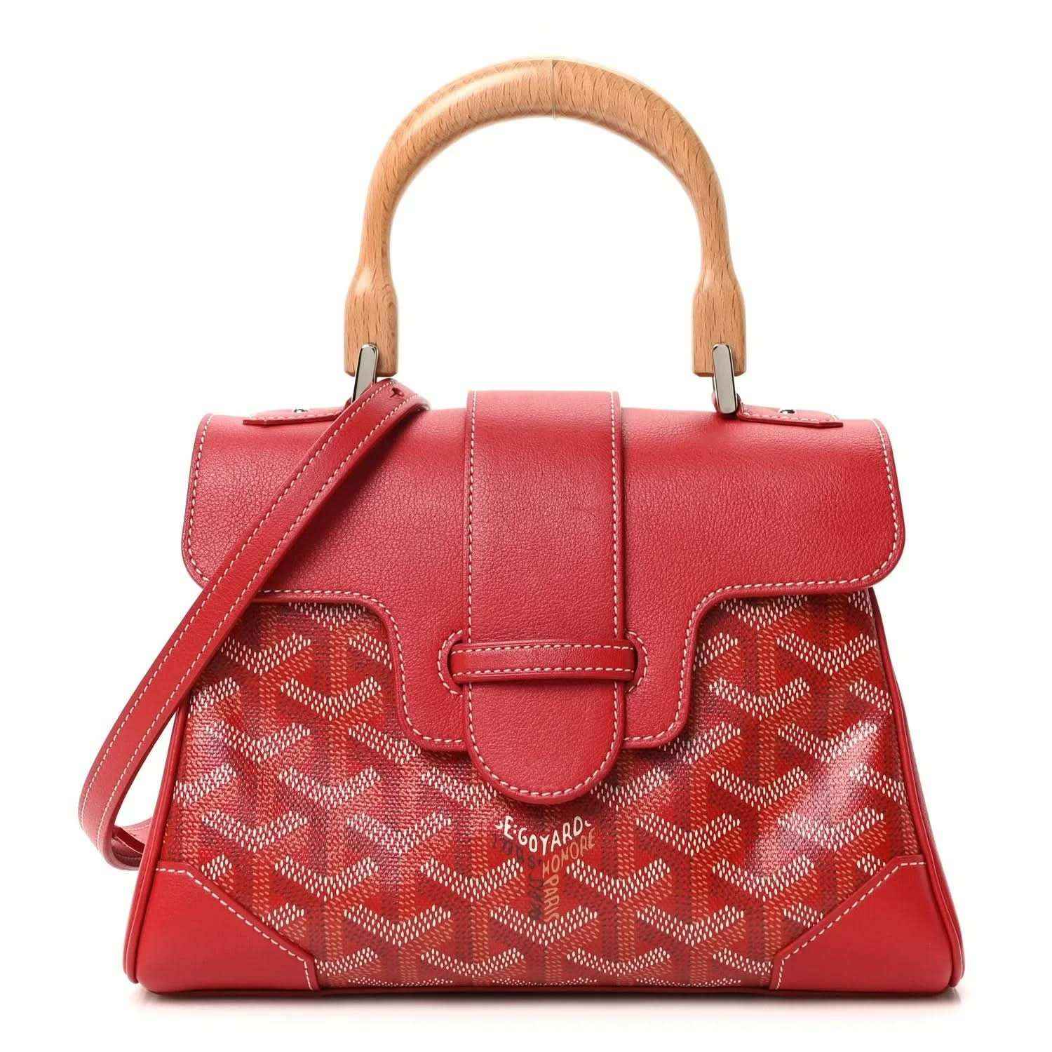 Red mini handbag with top handles, shoulder strap, flap, and patterned coated canvas.