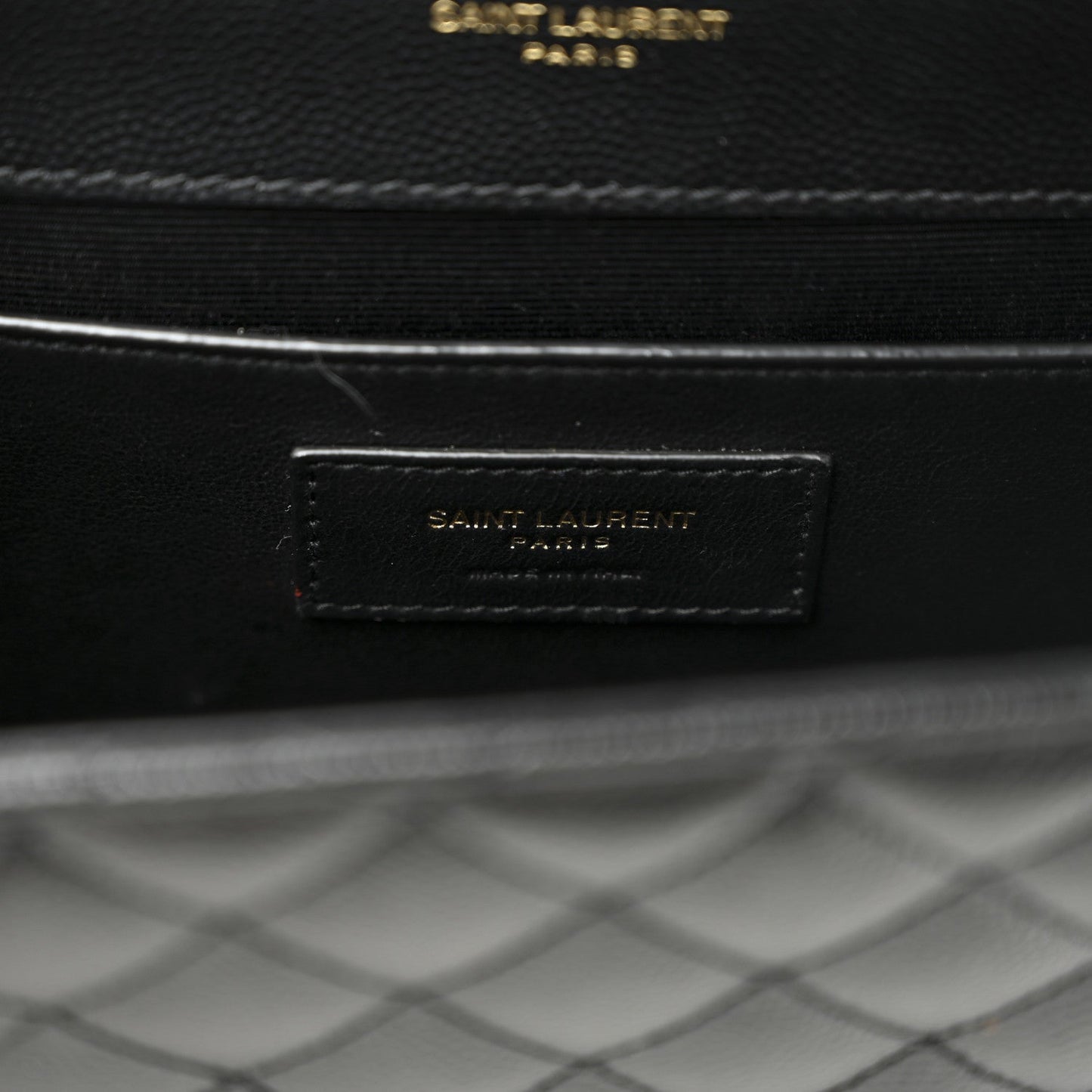 Black leather interior label with “SAINT LAURENT” text