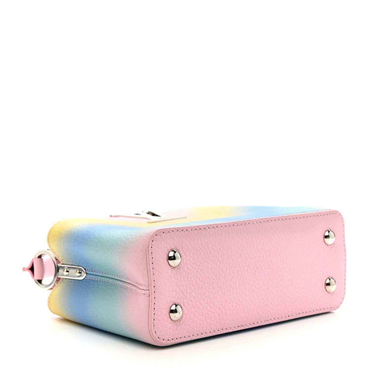 Mini Capucines bag side view, pink leather base with rainbow gradient and metal feet