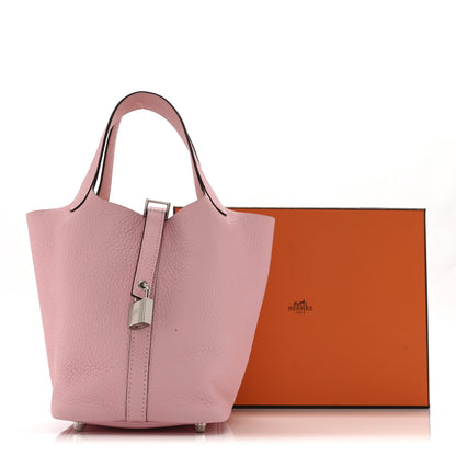 Mauve textured leather tote-style handbag with top handles and padlock strap