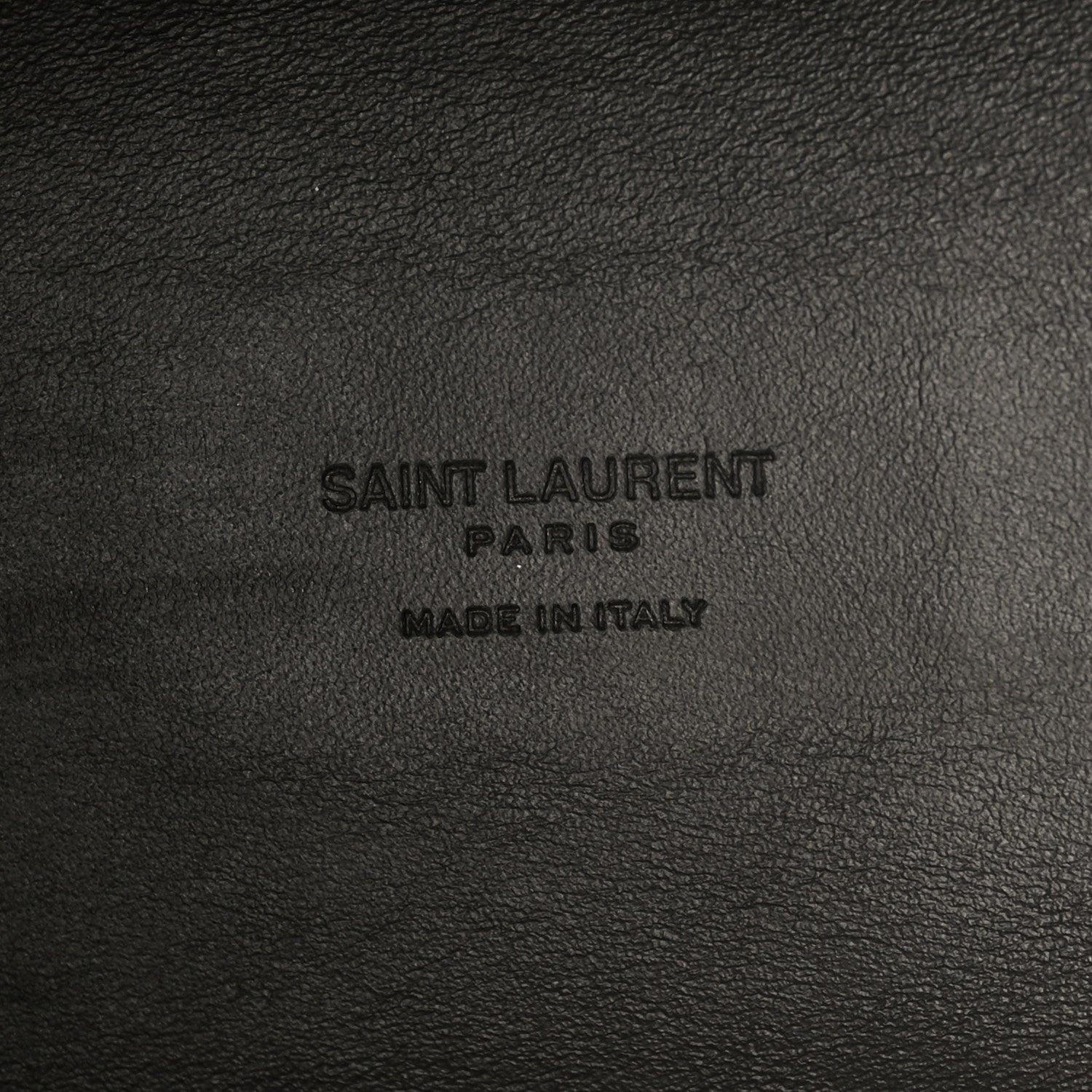 Saint Laurent Paris made in Italy embossing on black leather surface