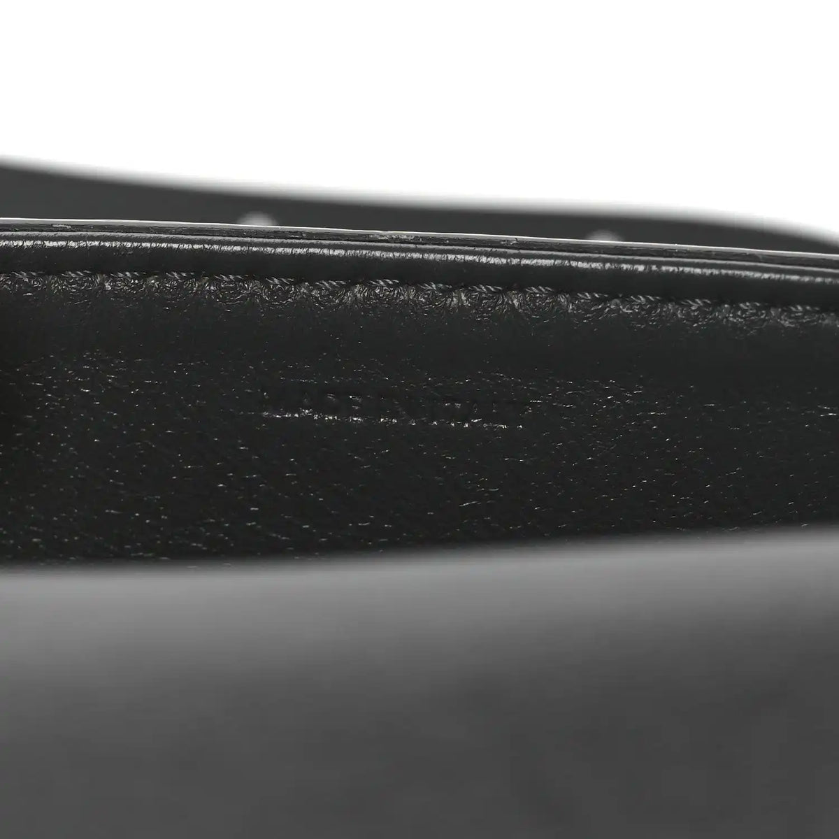 Close-up of black leather strap and grey snakeskin edge stitching