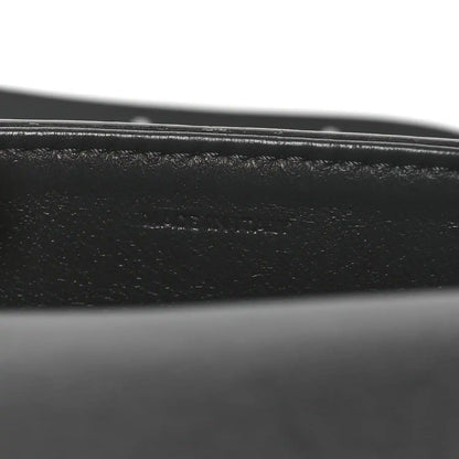 Close-up of black leather strap and grey snakeskin edge stitching