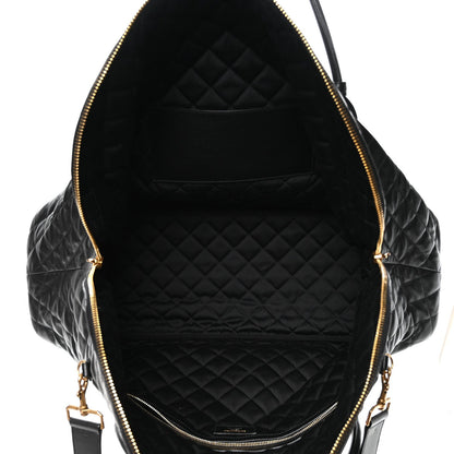 Black quilted leather interior with zippered opening and gold-tone zipper pulls