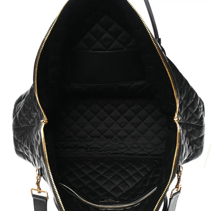 Black quilted leather interior with zippered opening and gold-tone zipper pulls
