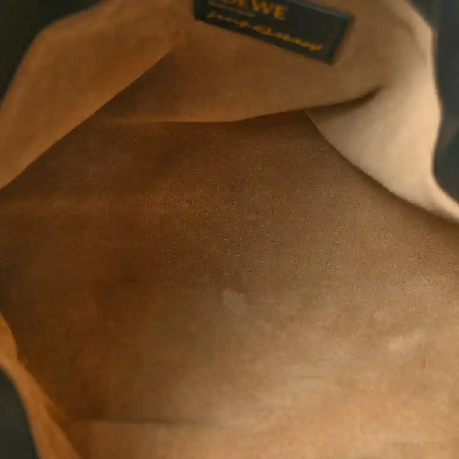 Nappa calfskin clutch interior with small Loewe label, showing “LOEWE” text