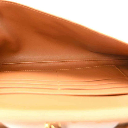 Amber suede clutch interior lining with open compartment and stitched edges