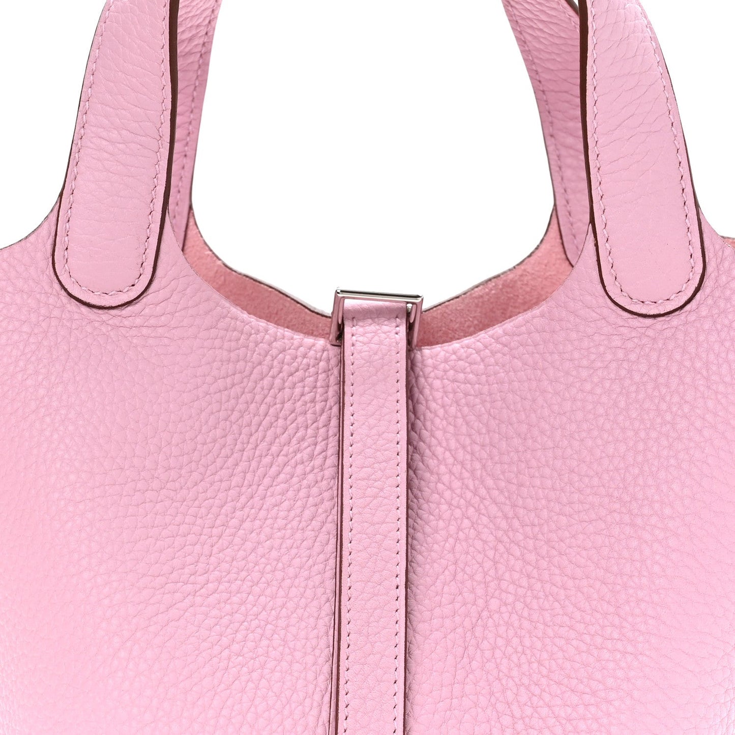 Rose pink leather handbag close-up of top handles and central lock bar