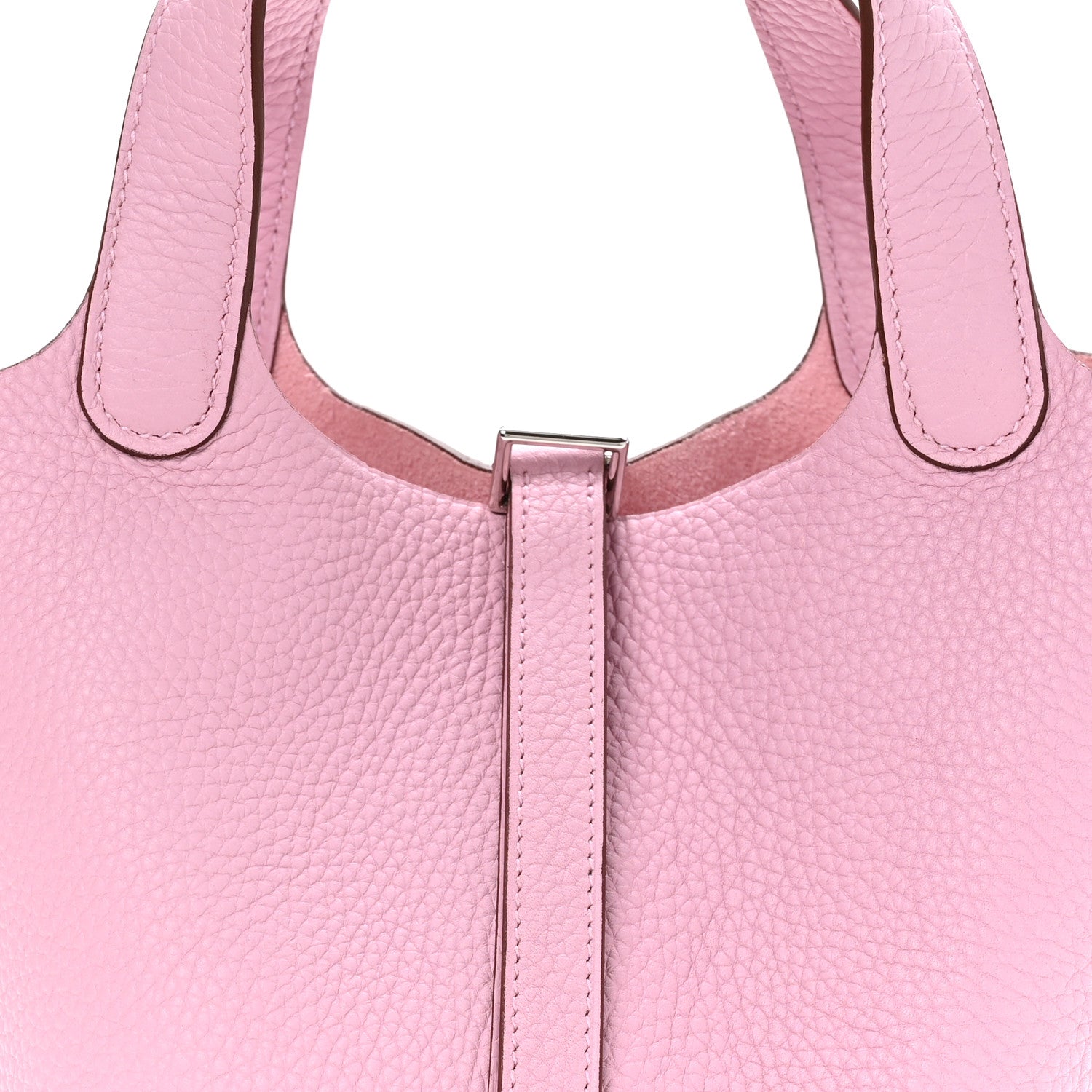 Rose pink leather handbag close-up of top handles and central lock bar