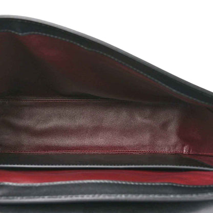 Black leather lining view with maroon-toned edge trim inside the bag