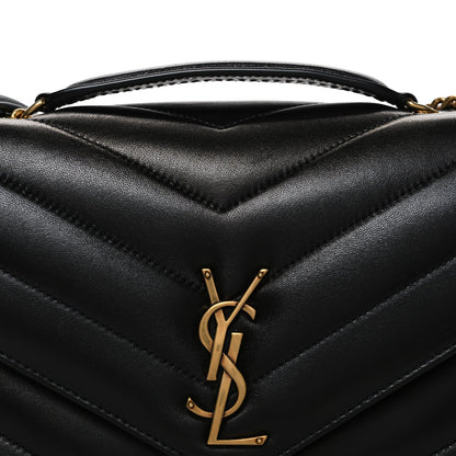 Black quilted lambskin flap with gold YSL logo and chevron stitching