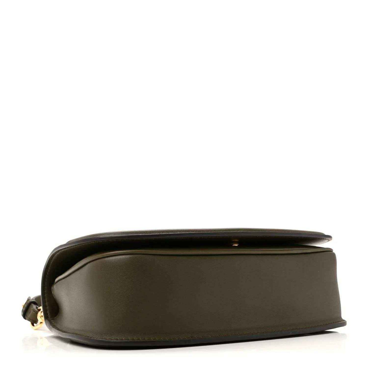 Dark green leather bag side view with rounded profile and top edge seam detail