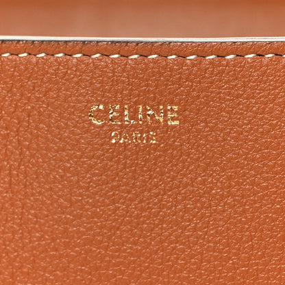 Tan grained calfskin close-up with embossed CELINE branding and stitched edge