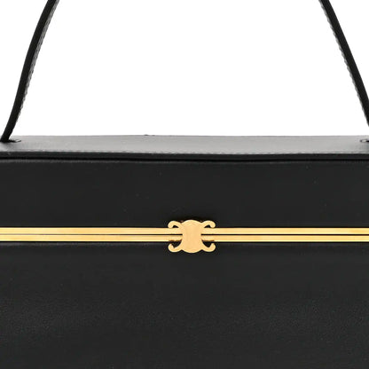 Black leather rectangle bag front latch with gold-tone bar and emblem