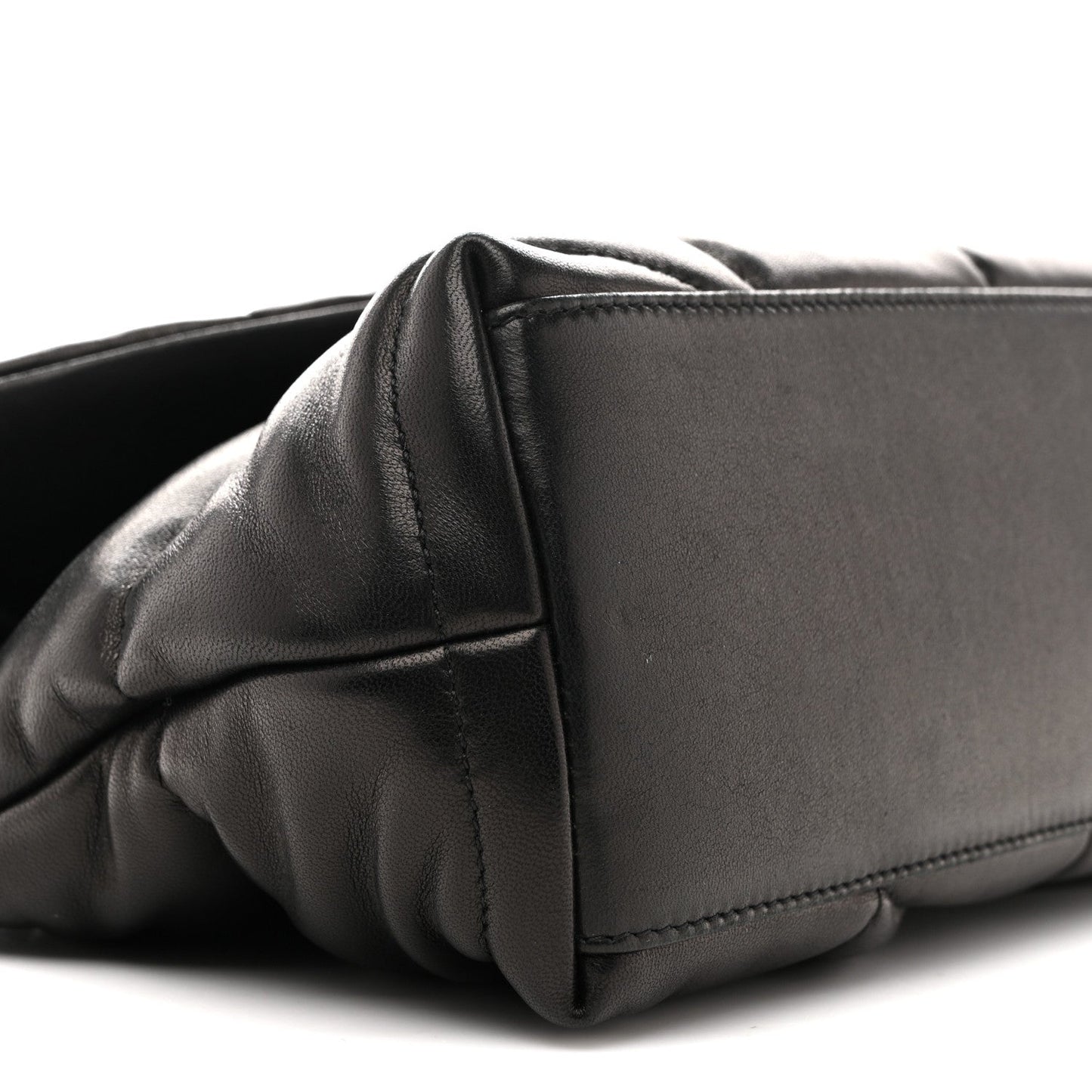 Black quilted puffer satchel corner with structured leather panel