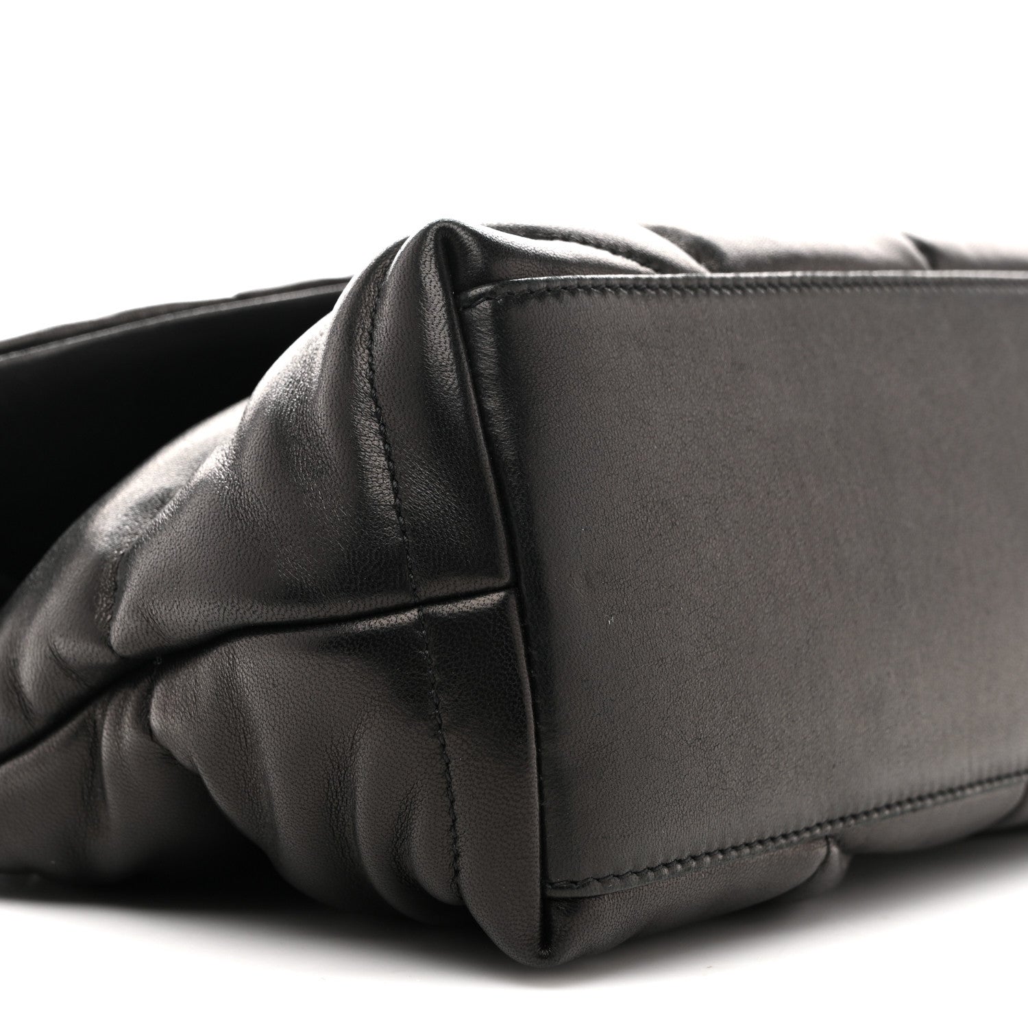 Black quilted puffer satchel corner with structured leather panel