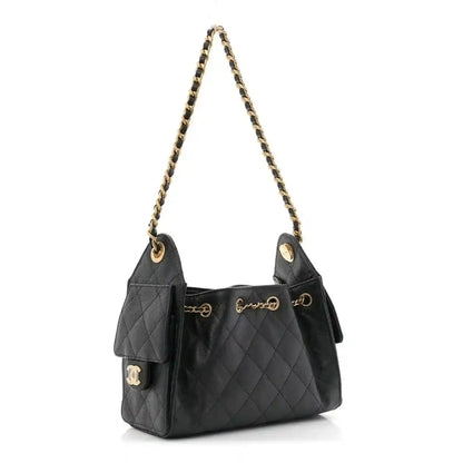 Black quilted mini handbag with top handles, chain strap, and CC charm