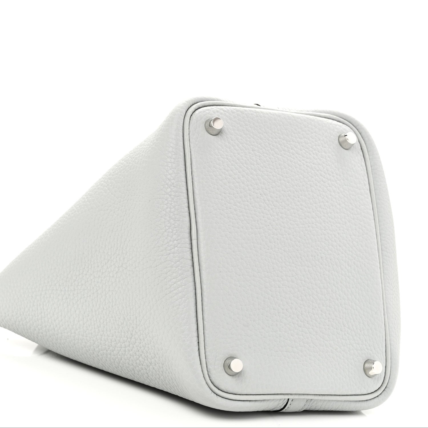 Light blue pebbled leather bucket bag side with metal corner studs and base seam
