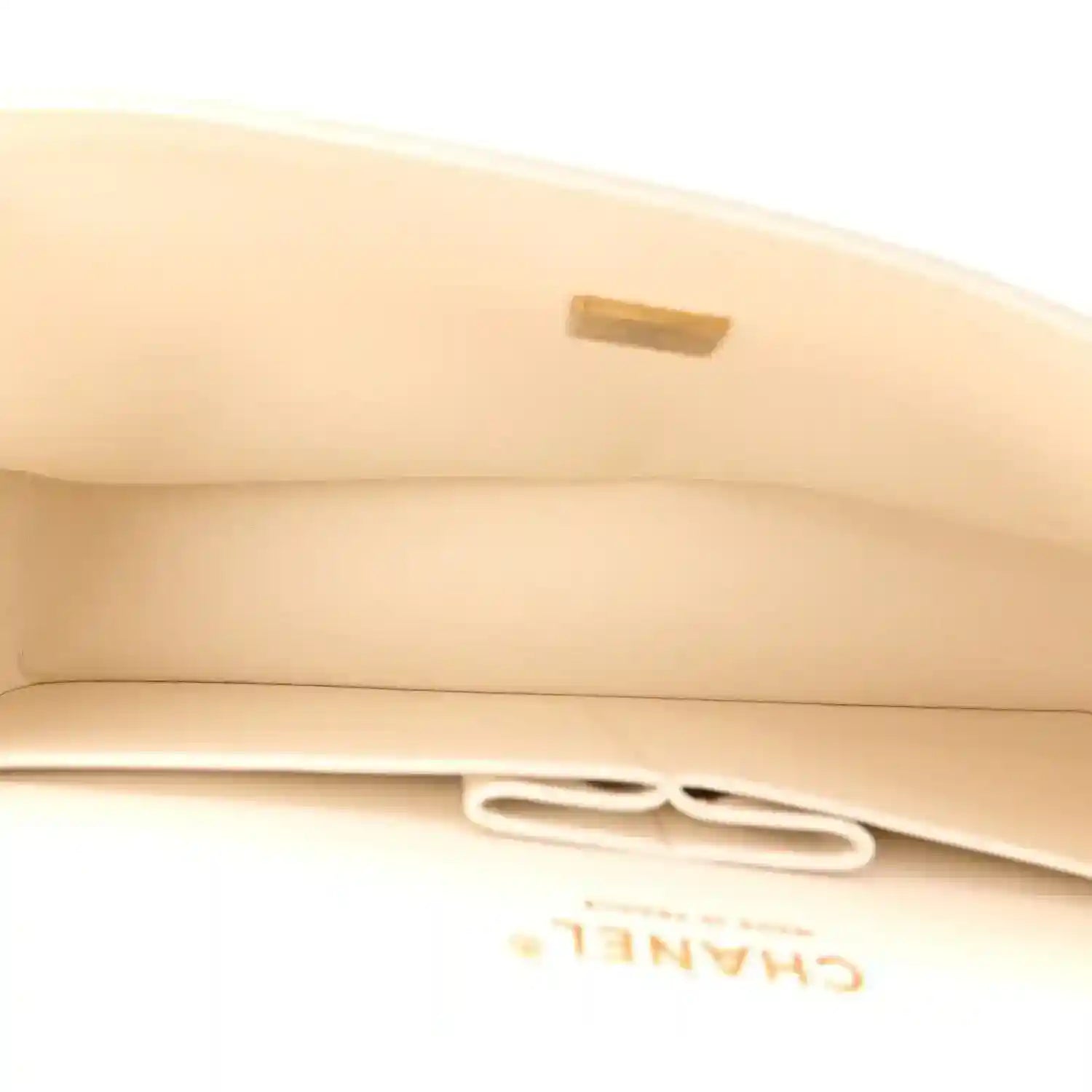 White quilted bag flap with gold-tone clasp detail