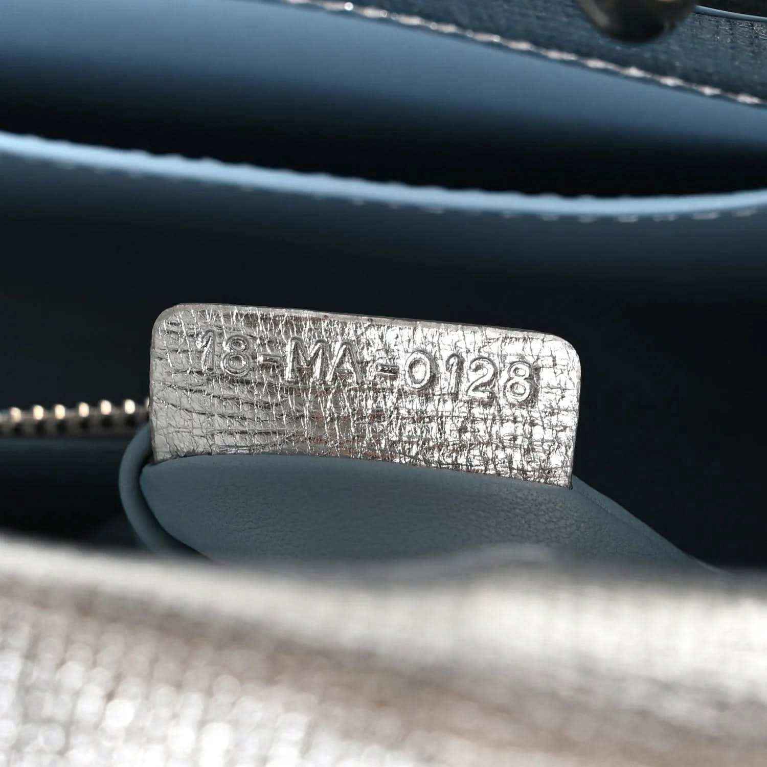 Blue leather bag lining with embossed code tag and zipper edge
