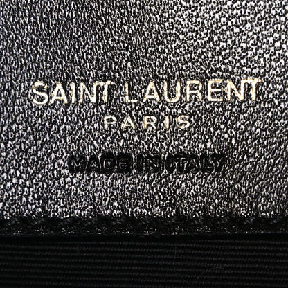Black textured leather interior label with "SAINT LAURENT PARIS" embossing