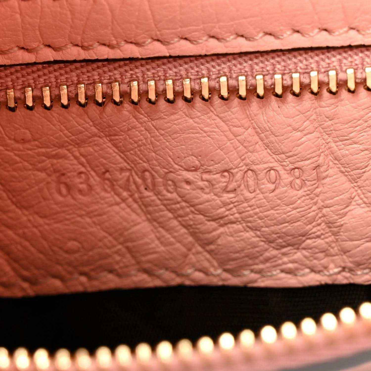 Gucci small hobo bag zipper close-up on pale pink grained leather