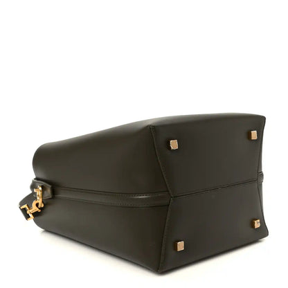 Saint Laurent calfskin bucket bag base view in deep musk with gold-tone corner studs.