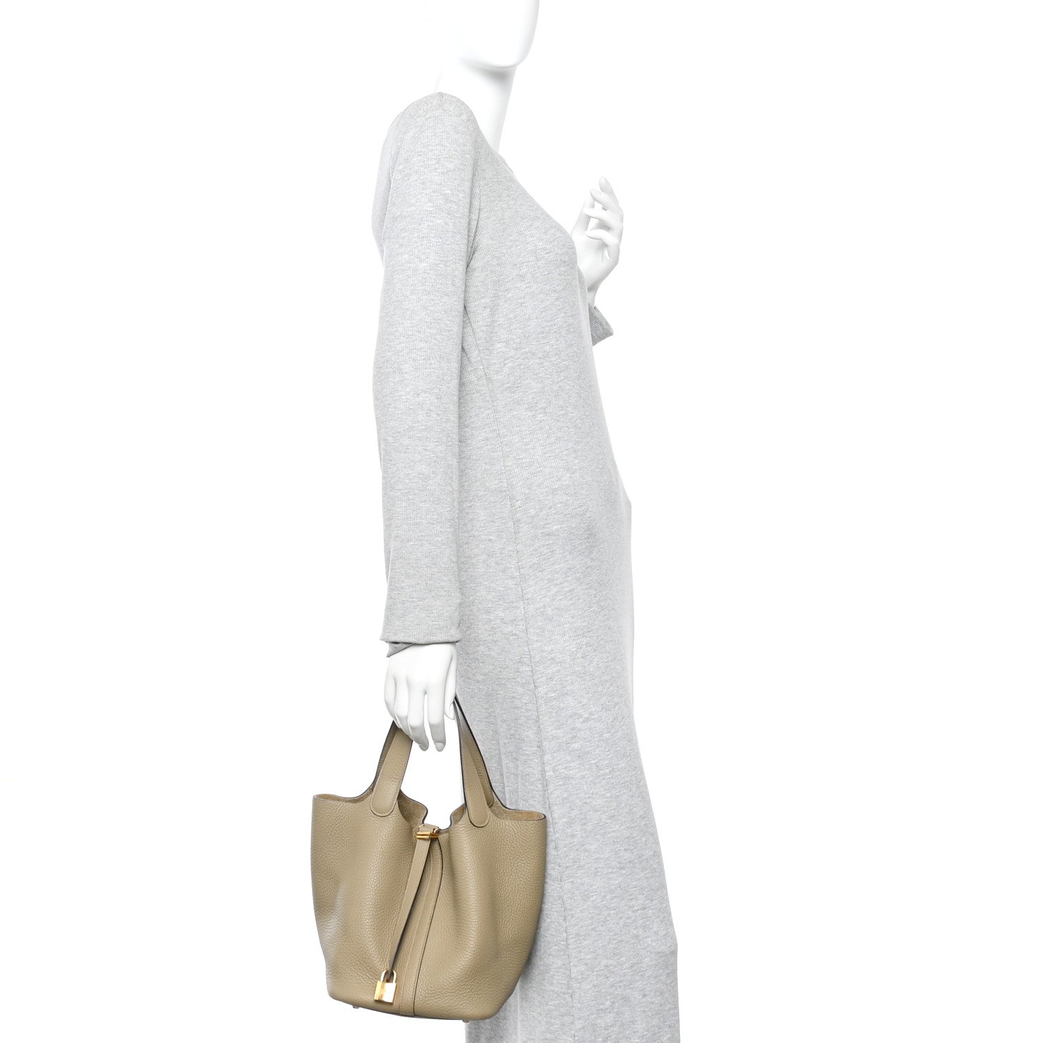 Beige leather mini tote worn on a model with short top handles