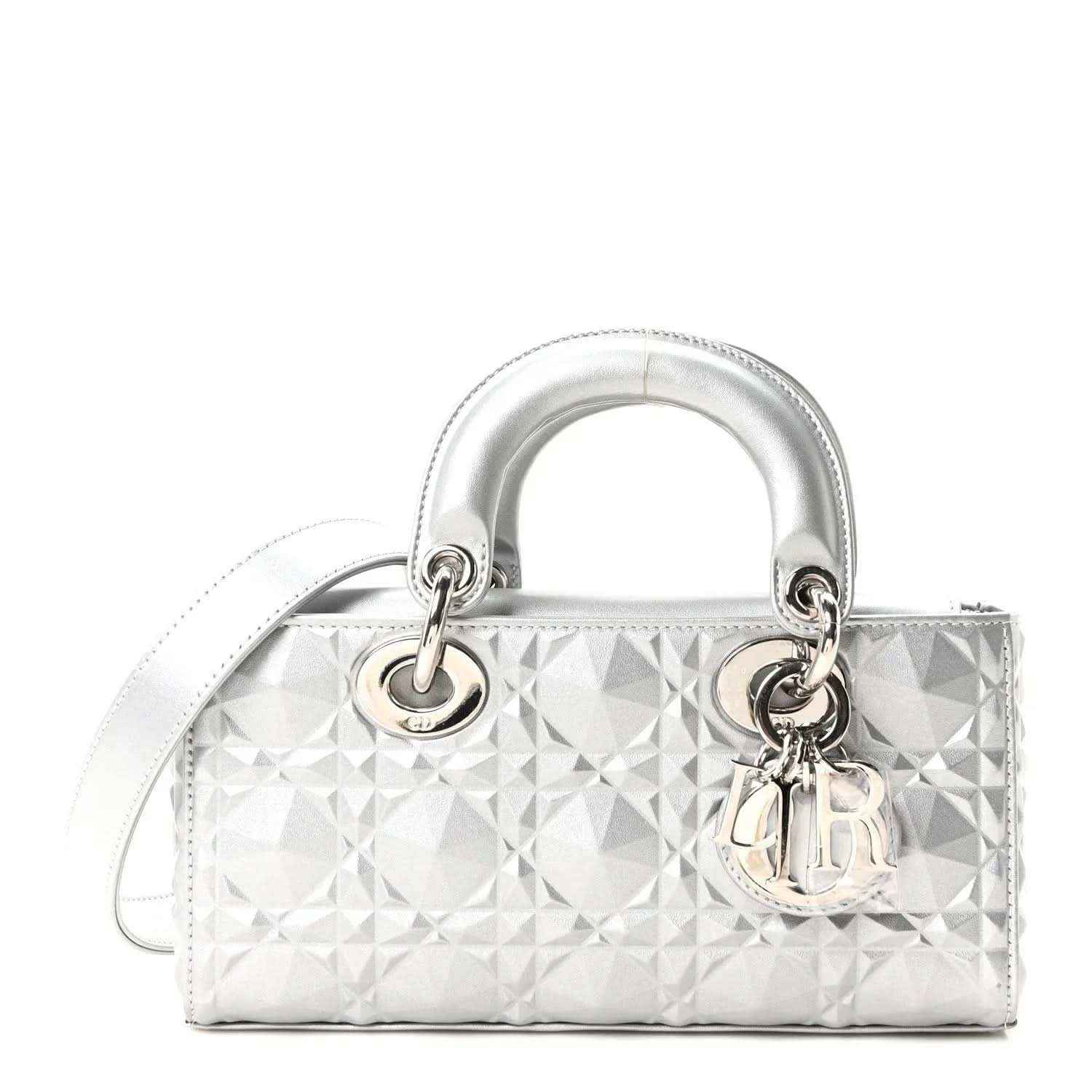 Small metallic silver handbag with geometric canage texture, top handles, and flap closure.