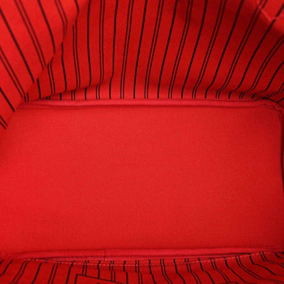Tote bag interior lining in red fabric with stitched seam and striped edge trim