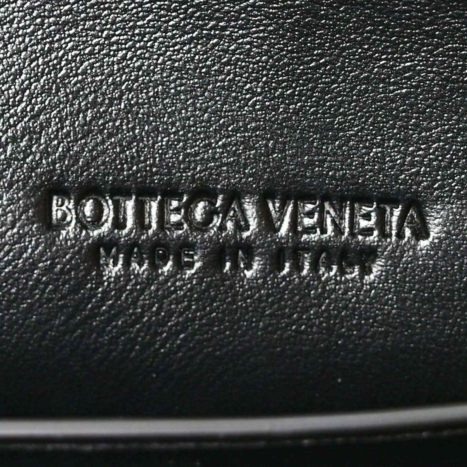Bottega Veneta logo stamp on black leather clutch