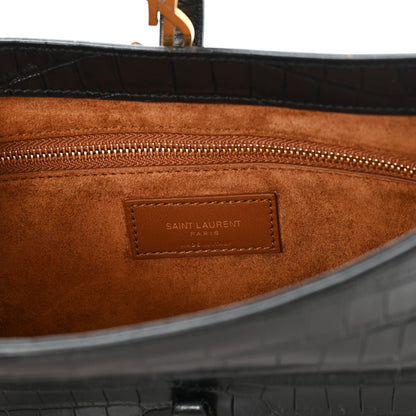 Brown suede-like interior panel with debossed Saint Laurent branding patch