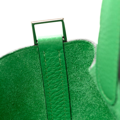 Green leather tote bag with metal strap ring and handle attachment