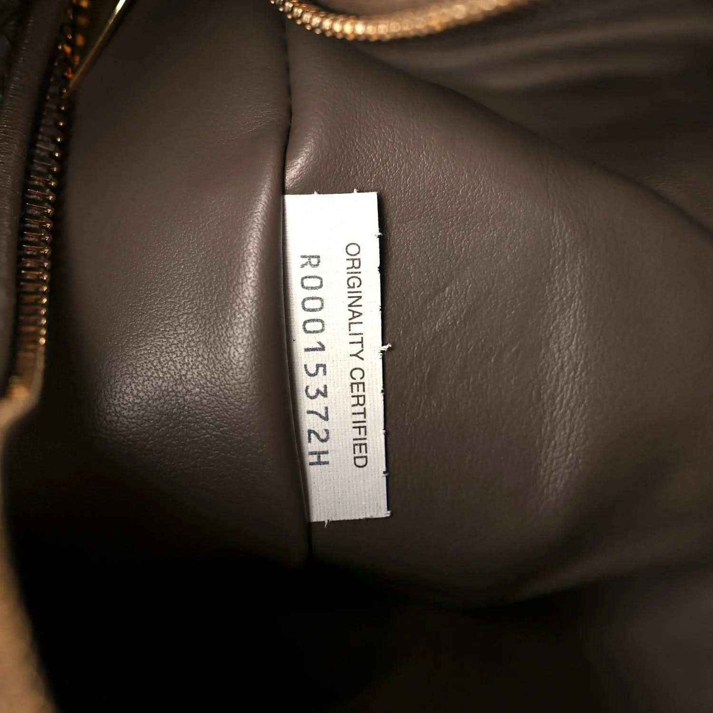 Taupe leather bag interior with “ORIGINAL CERTIFIED” size label
