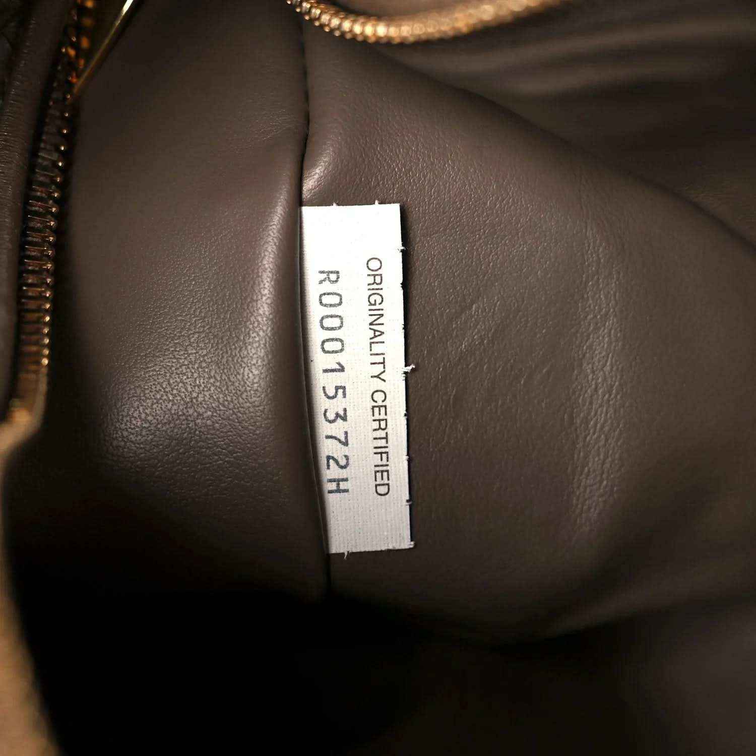 Taupe leather bag interior with “ORIGINAL CERTIFIED” size label