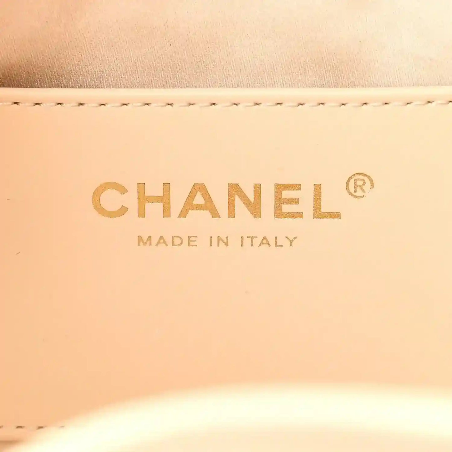 Chanel label on light beige leather reading “MADE IN ITALY”