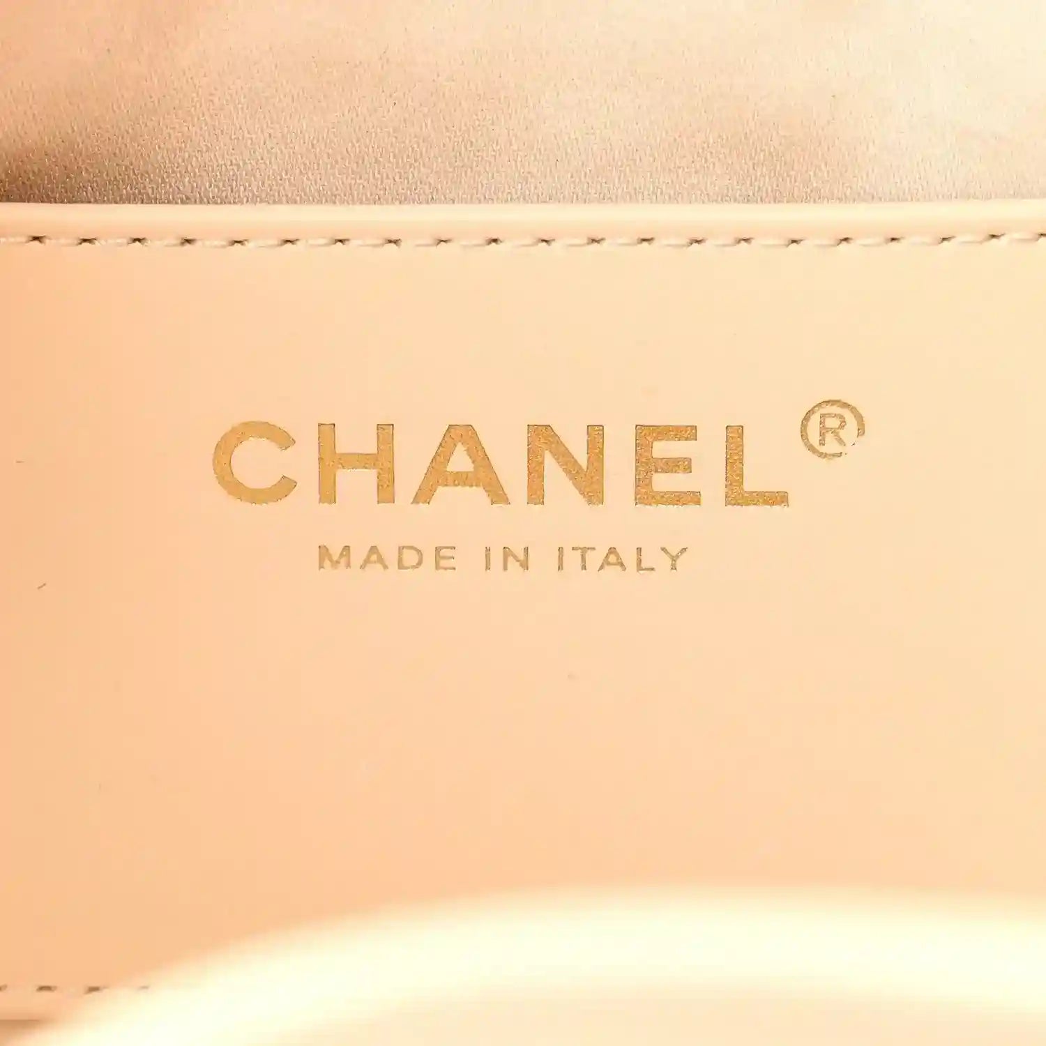 Chanel label on light beige leather reading “MADE IN ITALY”