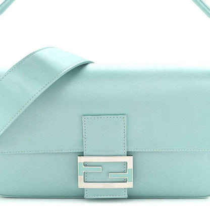 Blue satin baguette bag close-up of front FF-style clasp and stitched flap