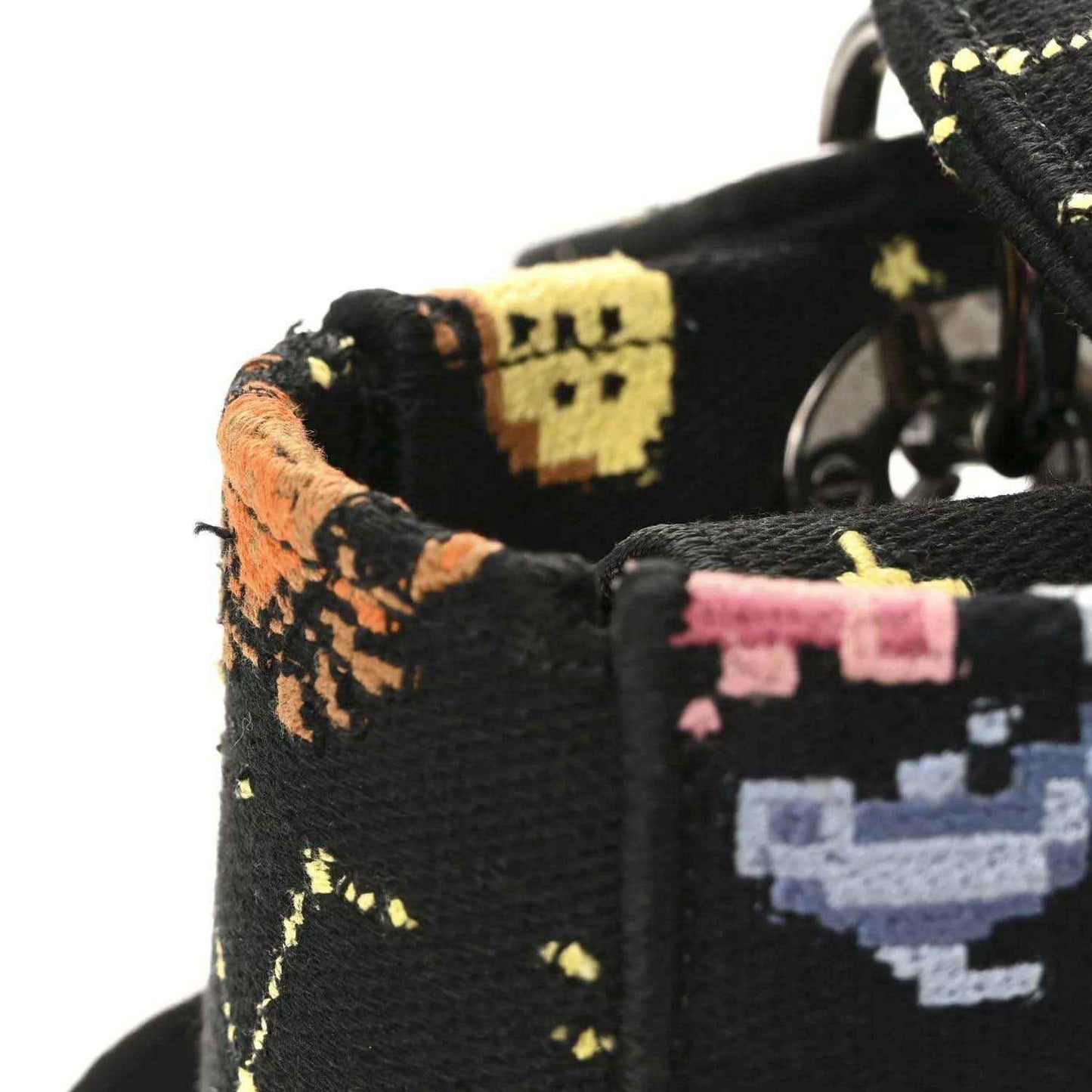 Black canvas bag side panel with multicolor zodiac embroidery and leather edge