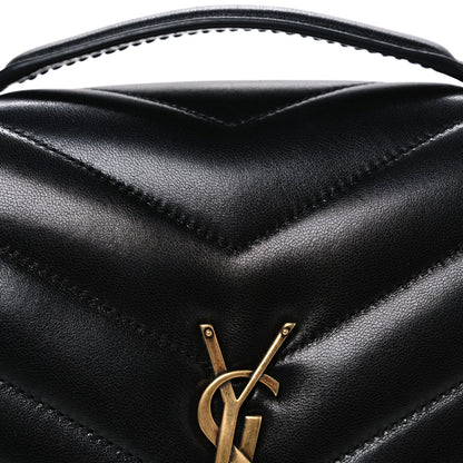 Black chevron quilted flap with gold YSL monogram clasp, close-up