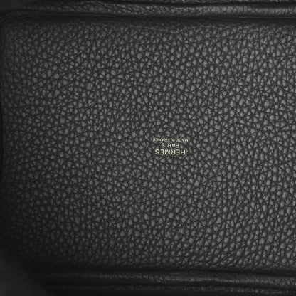 Textured dark green leather interior panel with stamped logo lettering.