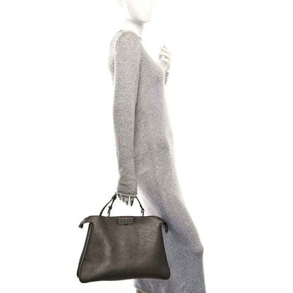 Fendi Peekaboo leather tote in tortora, worn on shoulder with small top handles