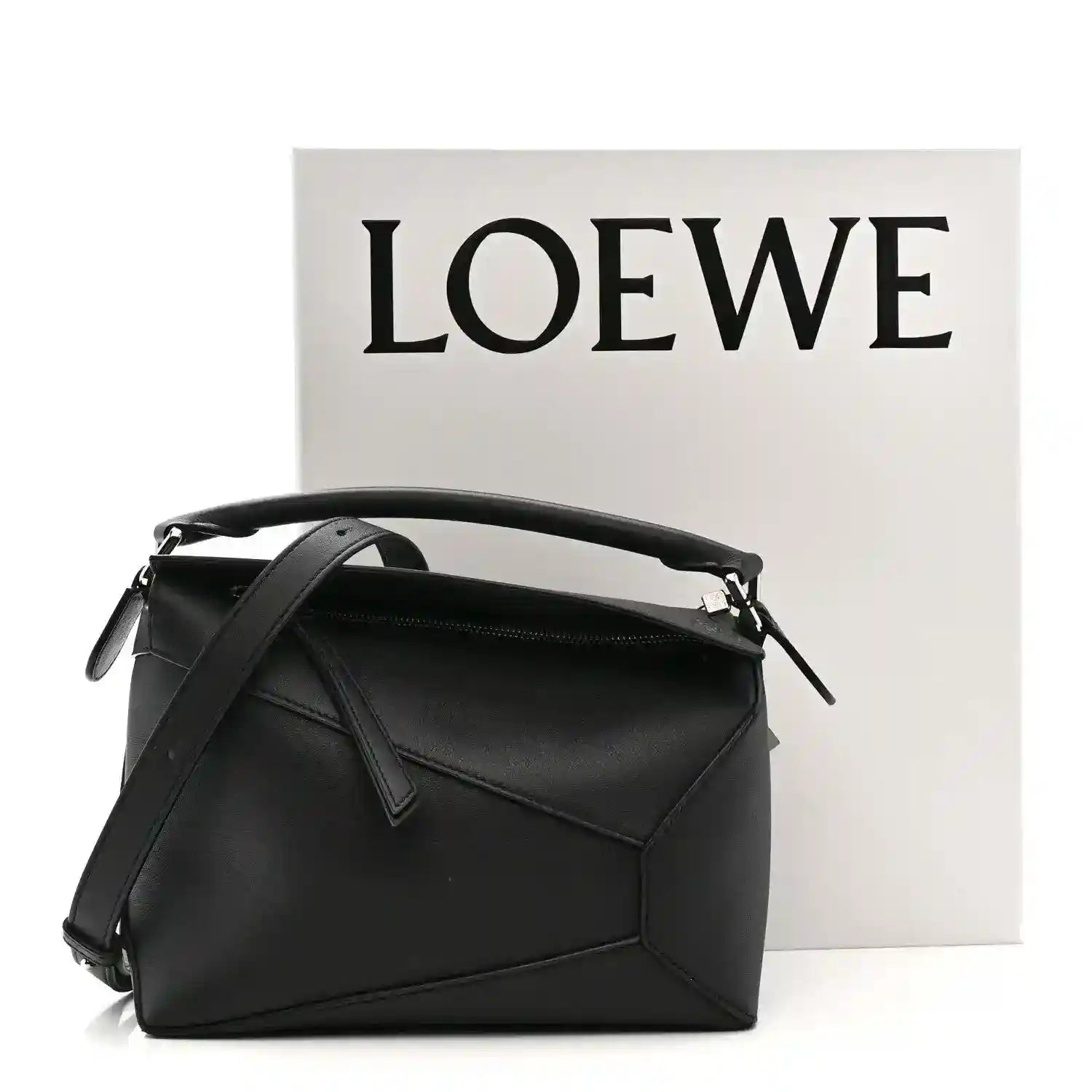 Small black calfskin shoulder bag with top handle, shoulder strap, and front flap