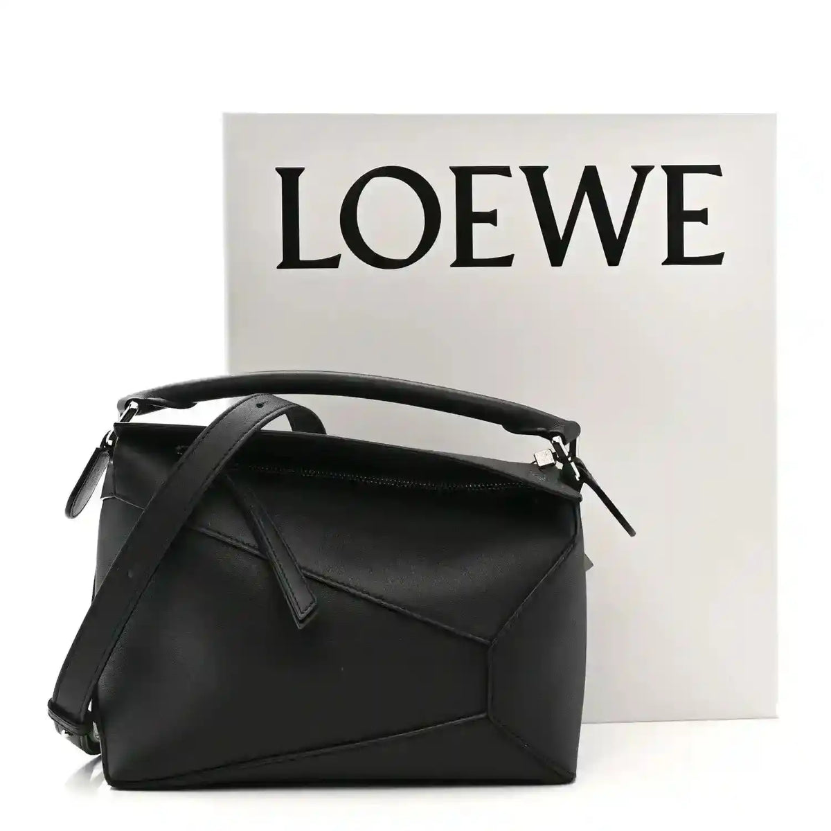 Small black calfskin shoulder bag with top handle, shoulder strap, and front flap