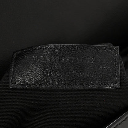 Saint Laurent black leather interior detail with embossed text area