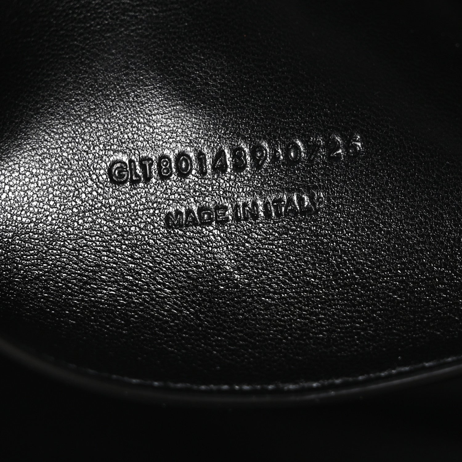 Black leather bag with stamped serial text on interior panel