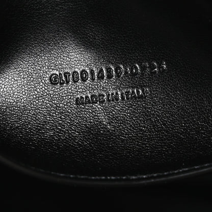 Black leather bag with stamped serial text on interior panel